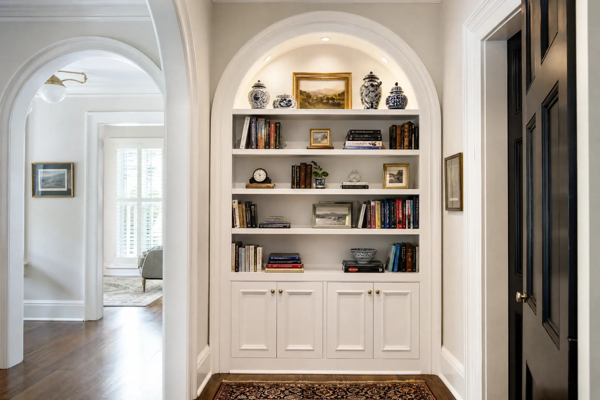 Arched alcove bookshelf with integrated puck lighting