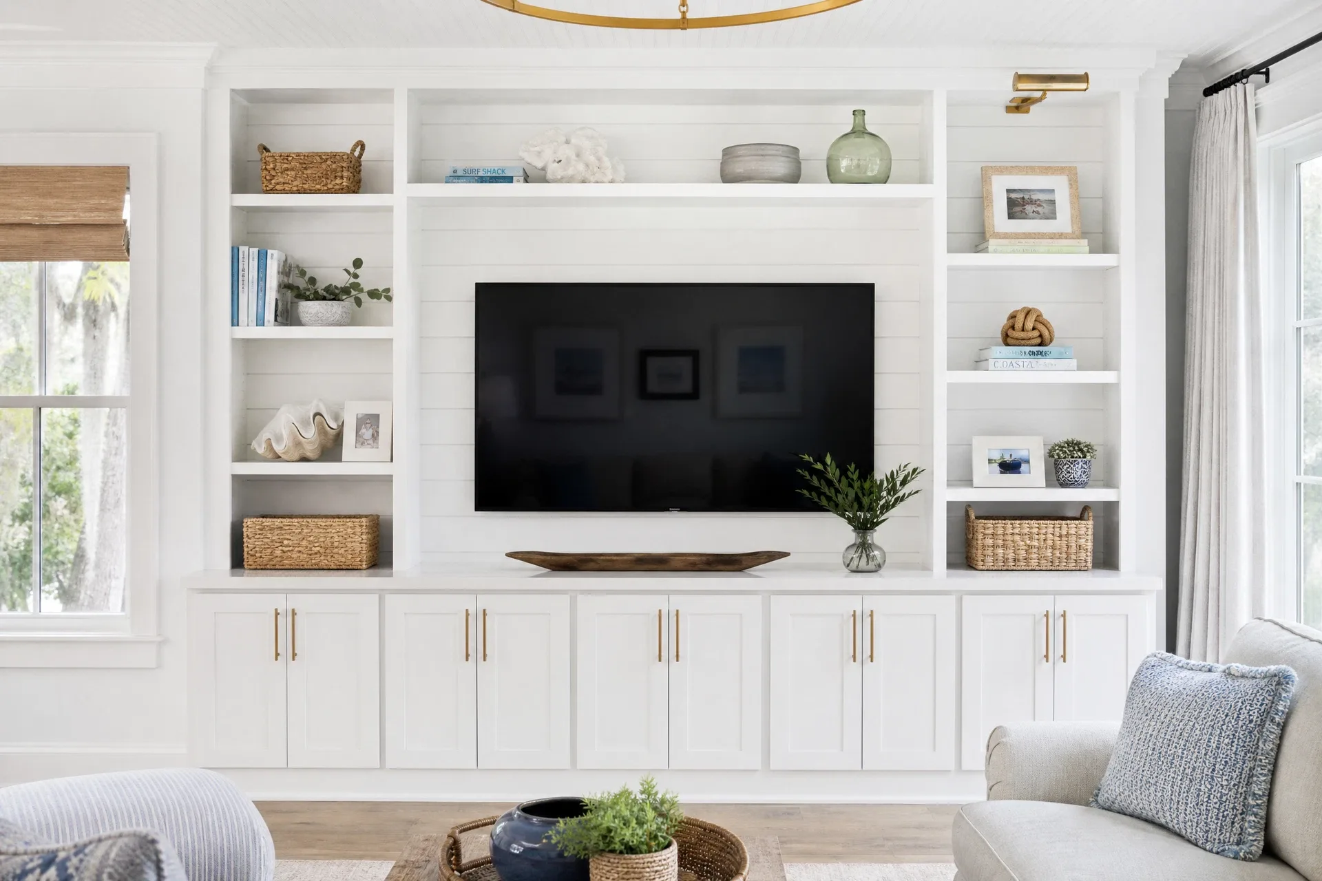 Coastal media wall with shiplap accent and brass hardware